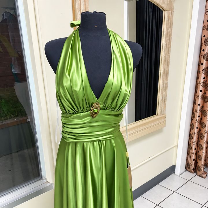 A green satin gown at the Arleta shop
