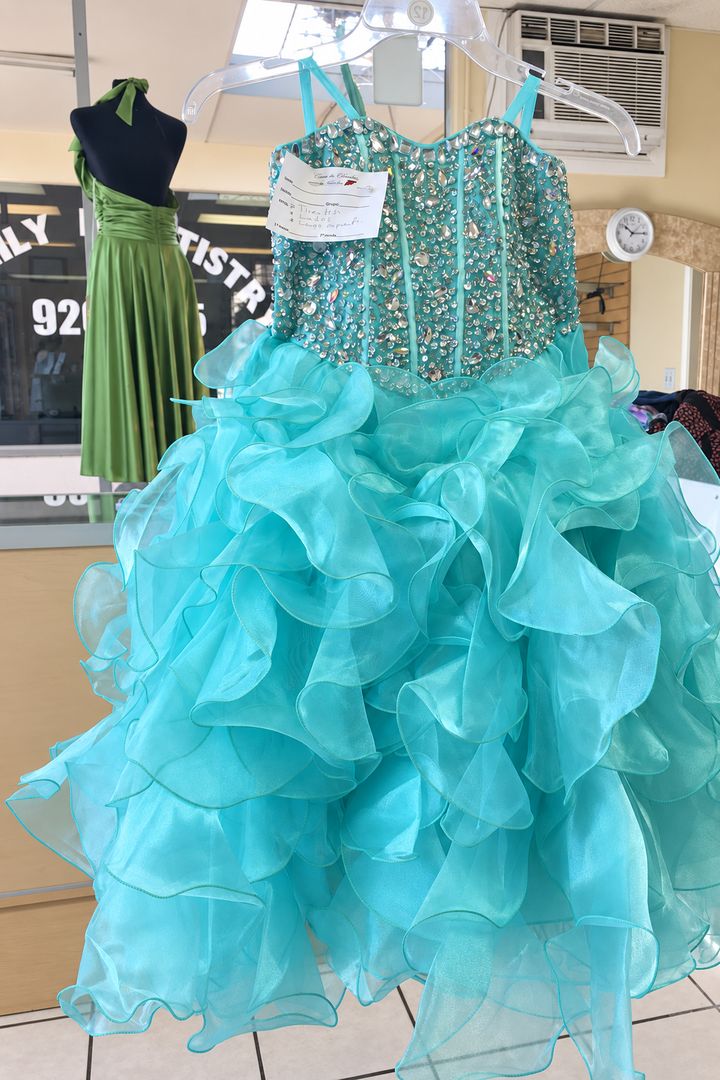 A ruffled turquoise gown at the Arleta shop