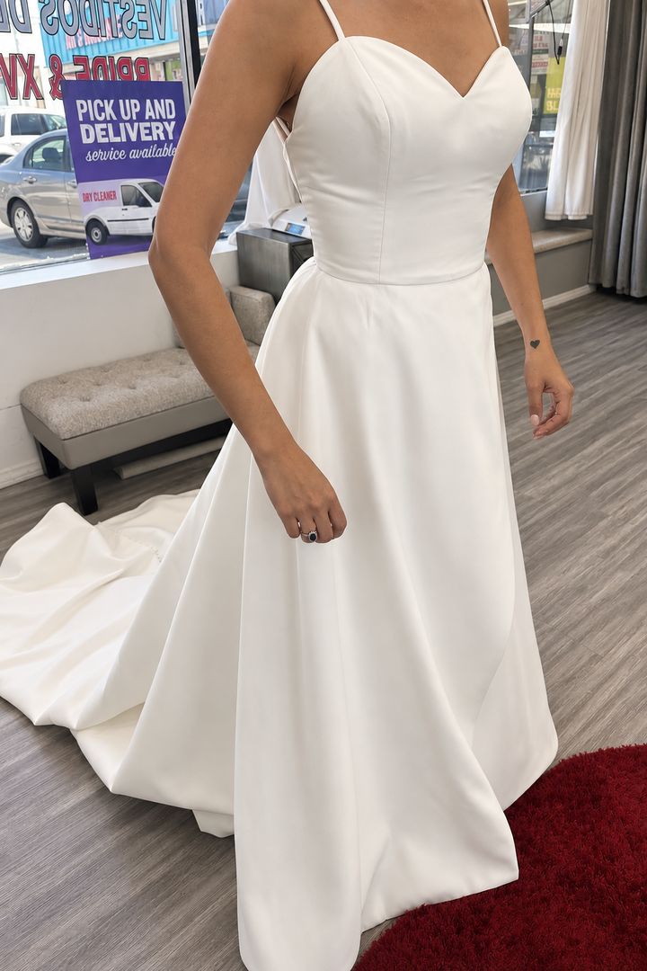 A satin wedding gown fitted at the shop